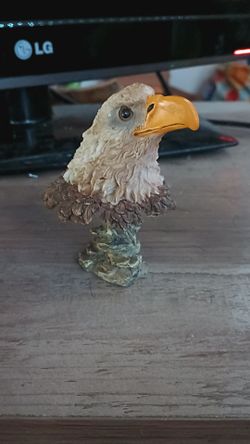 Small eagle head statue on a rock