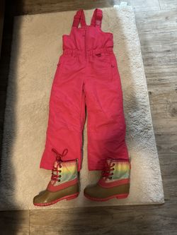 Pink snow pants and boots.