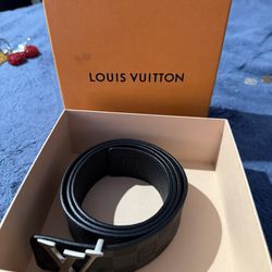 Louis Vuitton LV Initiales Damier belt with a large silver-toned LV buckle