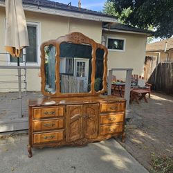 Vintage Wooden Dresser With Attached Mirror And  matching Nightstands .  Priced to sell . Slight discoloration and texture change on the surface of th