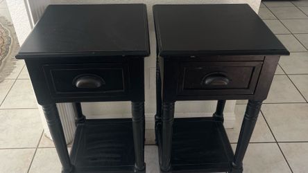Beautiful pair of tall wooden nightstands with a unique and practical design.