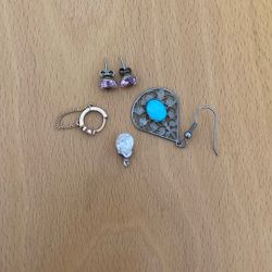 One pair of stud earrings, two single stud earrings, and one pendant.