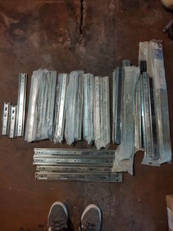 Lot of drawer slides for cabinets and dressers.