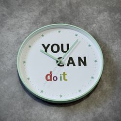Green and white clock with motivational quote