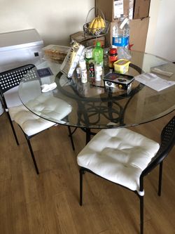 Two IKEA chairs and glass dining table