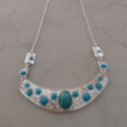 A Silver Necklace With Turquoise Stone