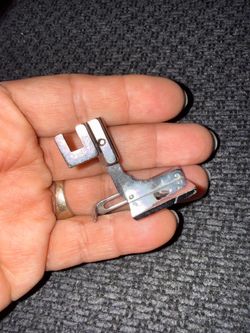 This is a curved hemming / folder presser foot
