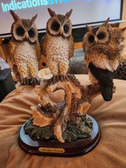 3 OWLS SITTING ON A PERCH