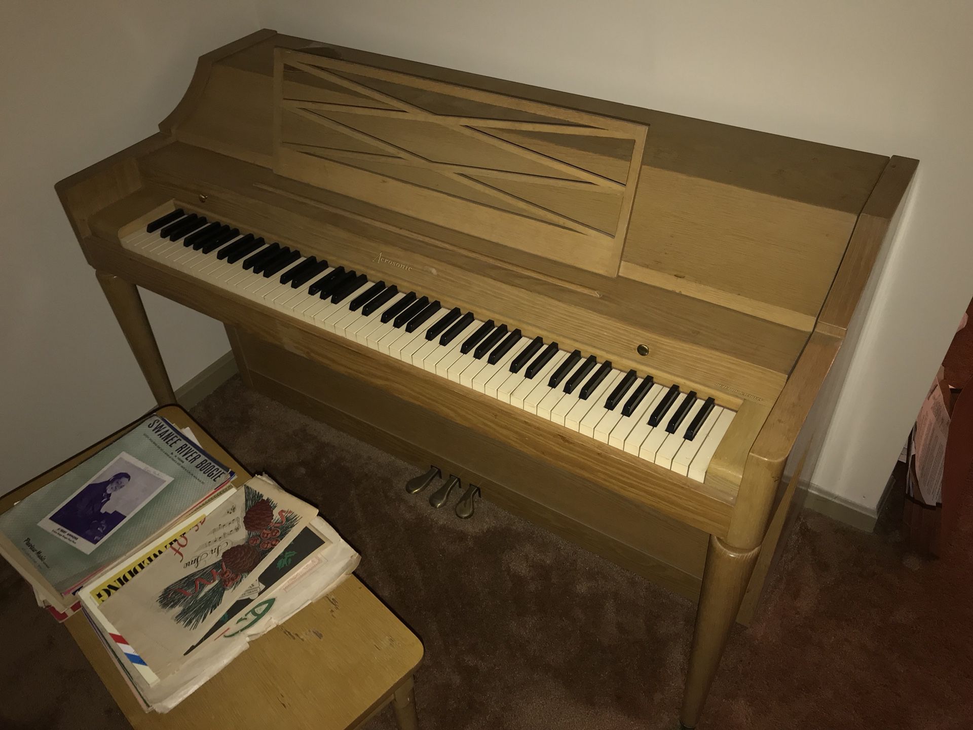 Piano with bench and much Sheet Music