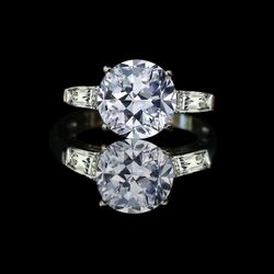 3 ct center round brilliant center stone with tapered baguettes. 635R1360