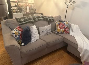 Beautiful gray L-shaped sectional sofa with chaise lounge