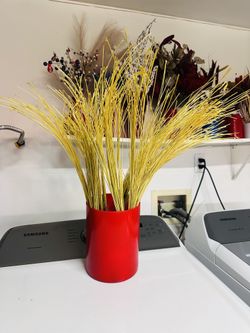 Yellow stick with red Ceremic vase