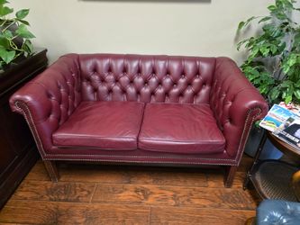 Tufted leather loveseat