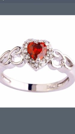 LADIES RING RUBY STERLING SLIVER STAMPED 925.RING WITH CUBIC ZIRCONIA'S. SIZE 10.