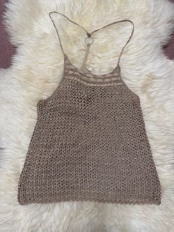 Open-knit crochet halter tank with ring detail at the back. Lightweight and breathable for warm days. Slim straps and subtle textured stitch work. Neu