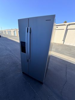 Refrigerator clean ready to use plugged in can show it working stainless steel