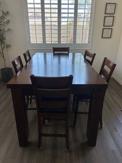 Brown wood dining table and chairs