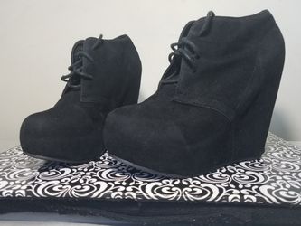 Black pair of wegde booties