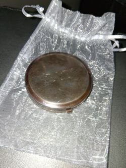 Tiffany & Co. sterling silver round trinket box. These boxes are often used for holding small treasures, jewelry, or mementos. 