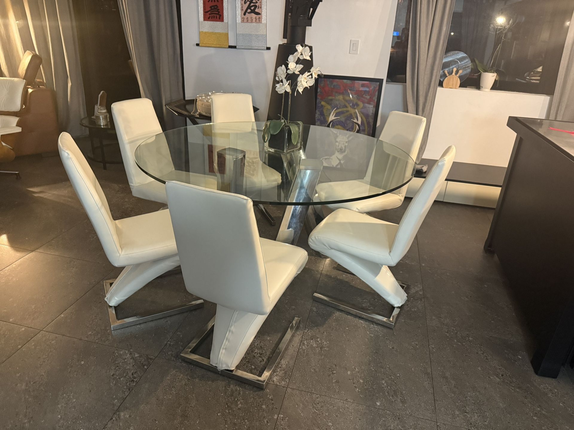 Beautiful Round And Glass Table With Leather Chairs
