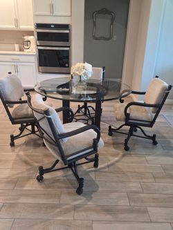 5 Piece Dining Set. Used, in good condition. Normal Wear!

Swivel Tilt Caster Dinette Set with Glass Top by Callee

48" Round glass-top table and four