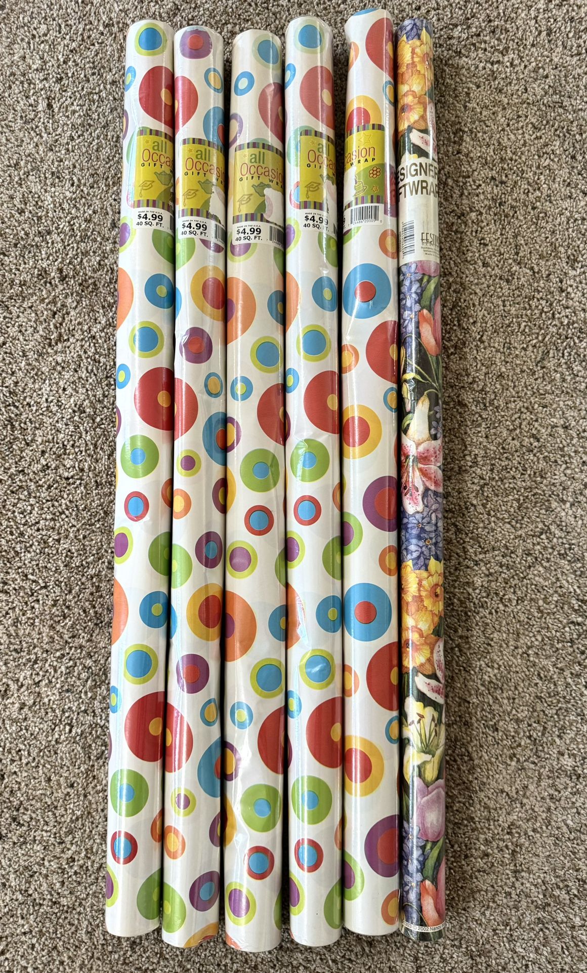 6 NEW rolls of Wrapping Paper. 5 are same with an “All Occasion” design & also 1 with floral look.