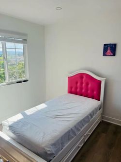 Twin bed with pink headboard