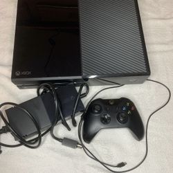 Xbox one black console with controller.