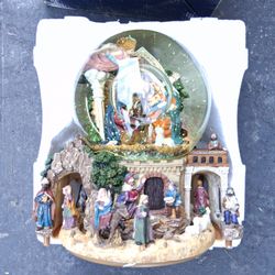 Kirkland Signature Nativity musical water globe featuring an intricate, hand-painted village scene surrounding a large water globe with a revolving ba