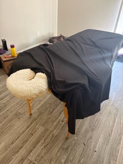 Massage table with sheet and headrest