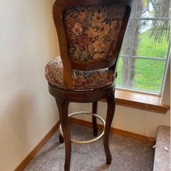 Tall backed cushioned swivel chair