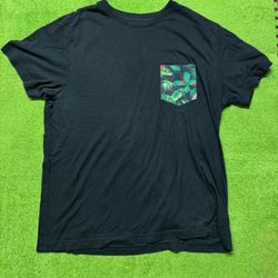 Black t-shirt with green and red tropical leaf print on pocket #tropical #summer