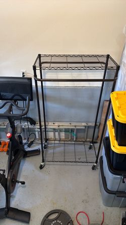 Metal rack with dual hanging shelves on wheels