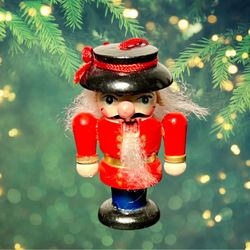 Vintage 1980s Hand-Painted Wooden Nutcracker Red Uniform Ornament, 2.75”  PLEASE NOTE: The first image is an artistic representation; all other photos
