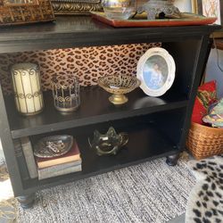 small black bookshelf or tv stand, leopard print back, adjustable shelf