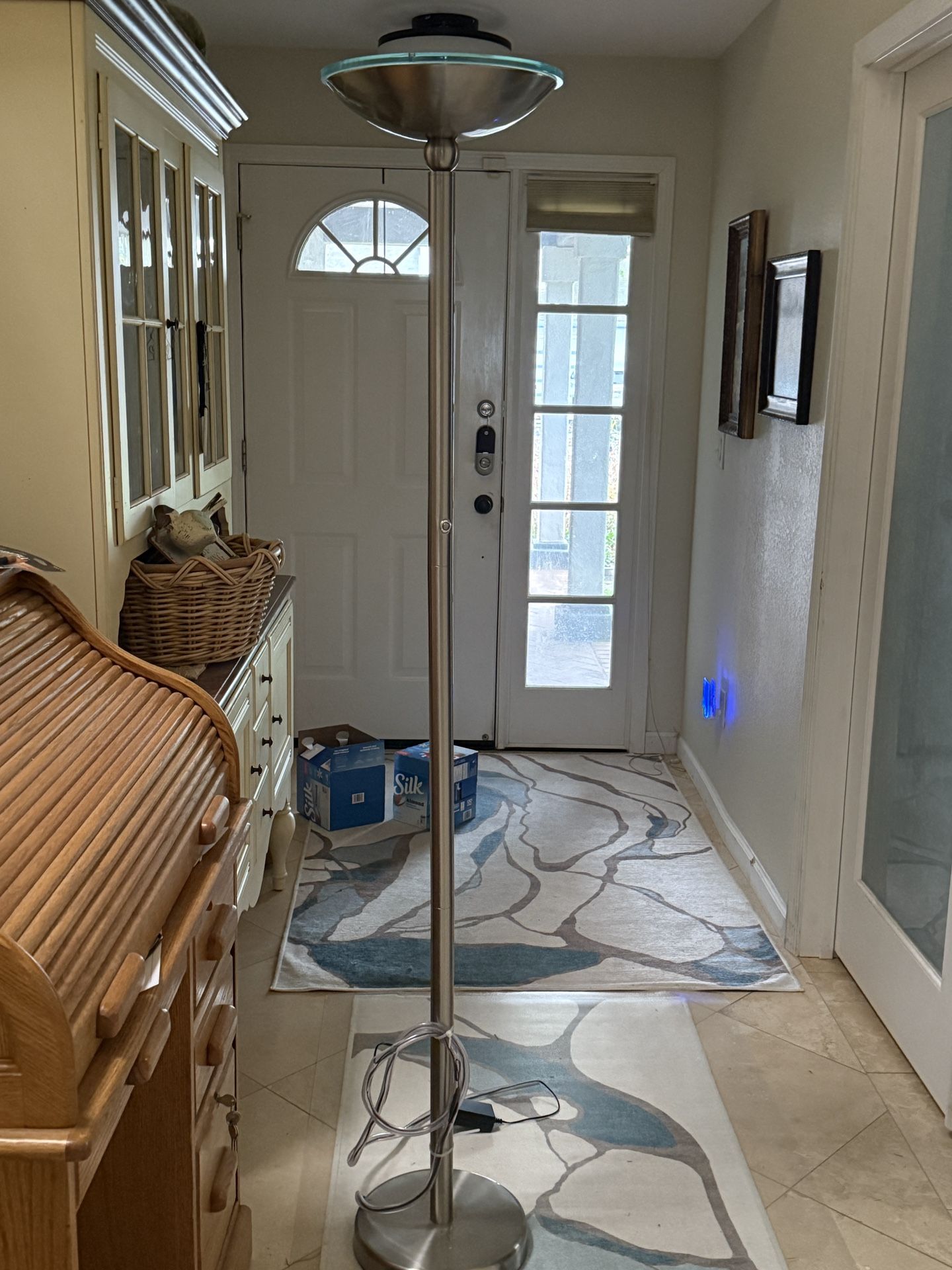 Torchiere Floor Lamp by Lavish Home brightens up your living space. With a sturdy metal base and an upward-facing marbleized glass shade, the lam