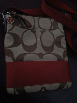 Coach purse for sell ...the strap part adjusts , its red && brownish color , its like a small decent purse .