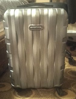 Gray Samsonite carry on size rolling suitcase