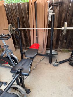 Weider Weight Bench with Barbell and Plates