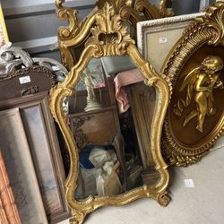 Antique Rococo-style carved gold-gilt ornate mirror.
