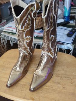 Pair of metallic gold cowgirl boots. Zipper with embroidery cowgirl boots.