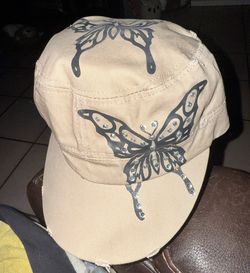 Tan women’s adjustable velcro hat with butterfly/diamond detail
