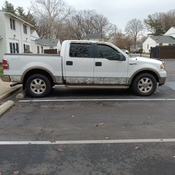 2005 King ranch F-150 Super crew Truck  White With Camouflage Trimming  Interior Brown Leather Has Tunnel Cover On The Back Of The Truck