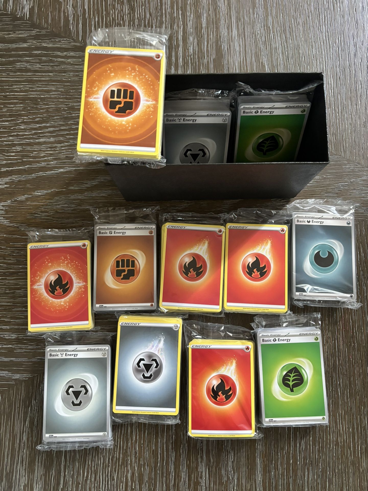 Trainer Box filled with 12 packs of sealed energy cards