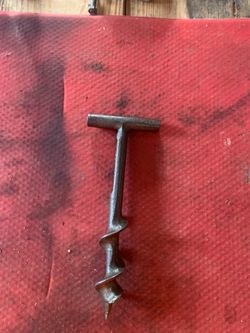 vintage T-handle wood auger, likely used for drilling holes in barn beams or in rustic