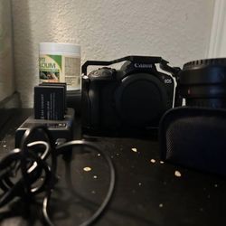 Canon R50 with rig cage, spare batteries, and EF-to-RF adapter. Shutter count: 13,277.