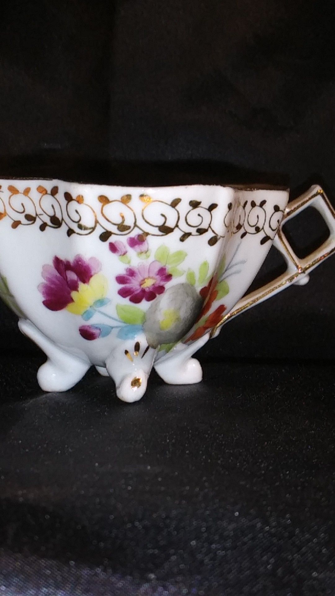Miniature Porcelain Tea Cup. Four Footed Hand Painted Gold Trim