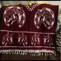 Really nice poncho has horses on both sides