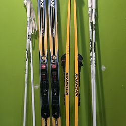 Two pairs of Cross country Rossignol Touring skis with automatic NNN bindings and poles