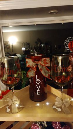 2 wine glasses and a vase with a candle.